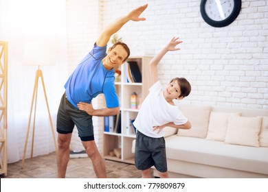 The man and the boy are engaged in gymnastics. This is father and son. They are at home. - Powered by Shutterstock