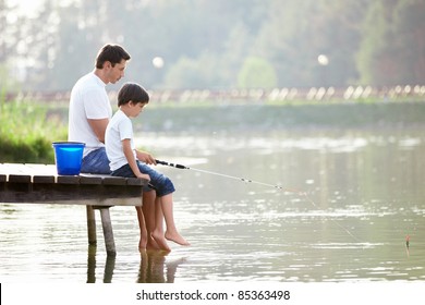 Man And Boy Fishing On The Lake