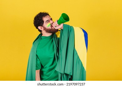 Man, Brazilian, Bearded, Soccer Fan From Brazil, Shouting Promotion With Voice Amplifier. Photo For Advertising, Advertisement And Promotion.