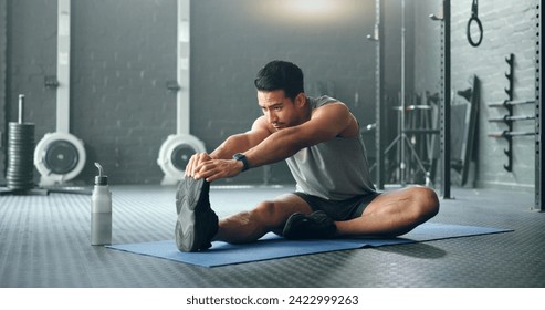 Man, break and stretching on gym floor in fitness, workout or training for strong muscles, heart health or cardio wellness. Japanese personal trainer, sports person or coach in body warmup exercise - Powered by Shutterstock