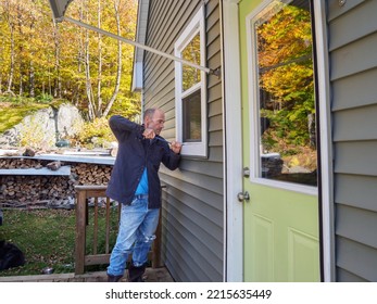 Man Breaking Into House Through Window