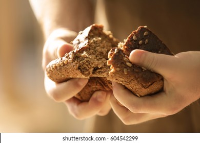 Man breaking off piece of bread, closeup - Powered by Shutterstock