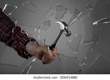 Man Breaking Window With Hammer On Dark Grey Background, Closeup