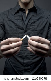 Man Breaks Cigarette - Smoking Cessation Concept