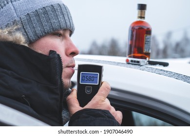 A Man With A Breathalyzer And A Bottle Of Alcohol In The Car, Testing For Alcohol And Drug Intoxication Of The Driver, Selective Focusing Tinted Image