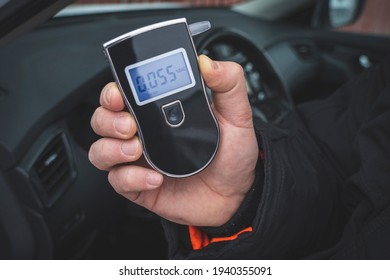 A Man With A Breathalyzer In The Car