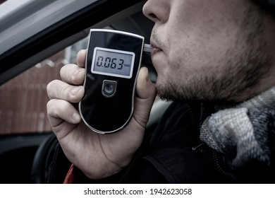 A Man With A Breathalyzer In The Car