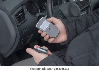 A Man With A Breathalyzer In The Car, Testing For Alcohol And Drug Intoxication Of The Driver, Selective Focusing Tinted Image