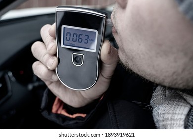 A Man With A Breathalyzer In The Car, Testing For Alcohol And Drug Intoxication Of The Driver, Selective Focusing Tinted Image