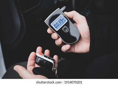 A Man With A Breathalyzer In The Car, Testing For Alcohol And Drug Intoxication Of The Driver, Selective Focusing Tinted Image