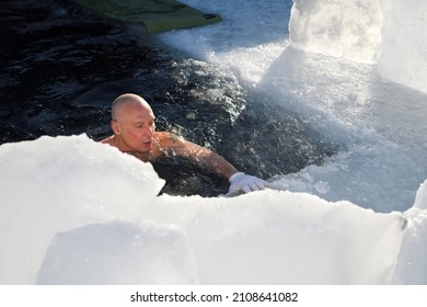 Man Breathing Deeply While Cold Water Swimming In Ice Hole On Kempenfelt Bay Lake Simcoe In Winter Barrie, Ontario, Canada - January 16, 2022