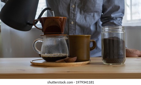 A Man Brewing Drip Coffee At Home.