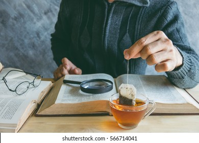 A Man  Brewing Tea Bag With Glass Of Tea On Table In Reading Time