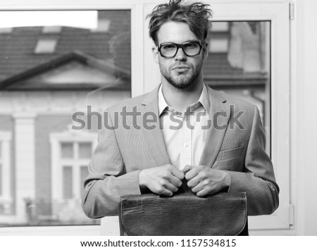 Man with briefcase isolated on white background. Nerd or brainiac wearing classic jacket. Bookworm syndrome and hard work concept. Serious teacher or worker with bristle in nerd glasses.