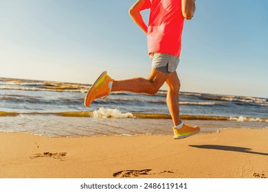 A man in bright athletic wear jogs energetically along the beach, showcasing fitness and coastal vitality.

 - Powered by Shutterstock