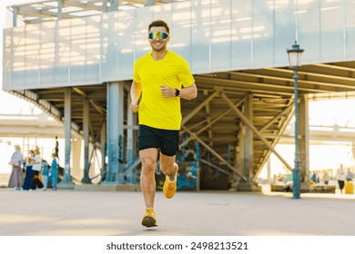 A man in a bright yellow sports outfit running confidently under an industrial bridge structure in daylight.

 - Powered by Shutterstock