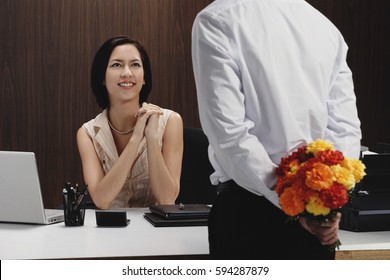 A Man Brings A Woman Flowers While She Is At Work
