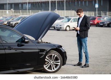 Man With Broken Car In The Middle Of The Road.