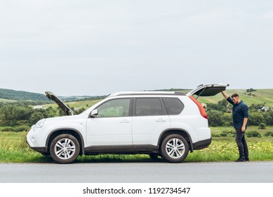 man with broken car at road side. insurance concept