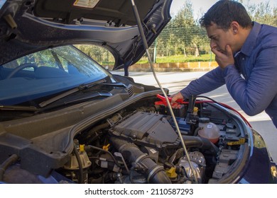 Man With Broken Down Car Due To Low Battery. Ignition With Cables