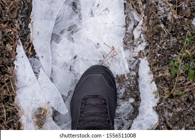 Man In Brown Nubuck Boots Is Breaking Or Crushing Ice. Waterproof Boots