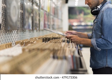 Man Browsing Vinyl Album In A Record Store