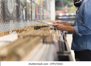 Man browsing vinyl album in a record store