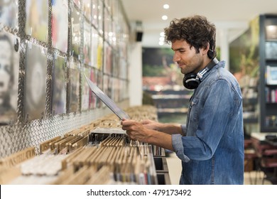 Man Browsing Vinyl Album In A Record Store