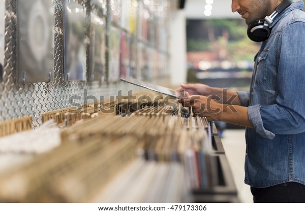 Man browsing vinyl\
album in a record store