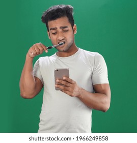 Man Brush Up His Teeth And Using Mobile Phone In Morning After Wake Up