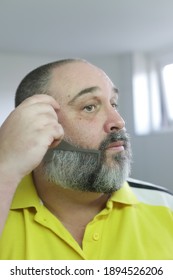 Man Is Brushing His Beard With Special Brush From Beard Grooming Kit.