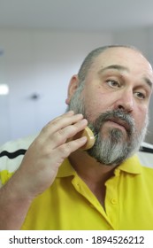 Man Is Brushing His Beard With Special Brush From Beard Grooming Kit.