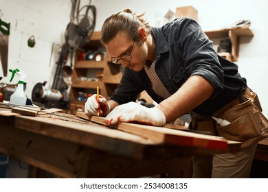 Man, builder and pencil to measure wood at workshop, carpenter and tool for precision design. Male person, gear and manufacturing furniture with equipment, creativity and plank notes for construction