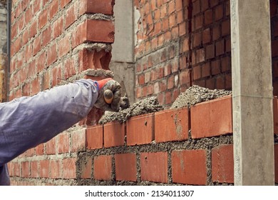 Man Building Brick Wall With Cement        