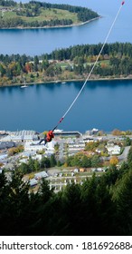 A Man Is Bungee Jumping In Queenstown New Zealand