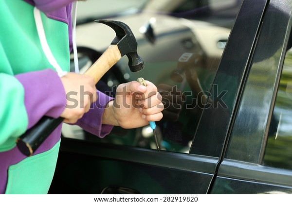 Man burglar stealing\
car
