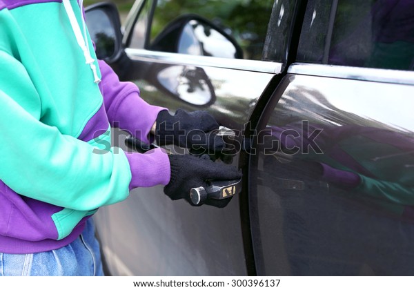 Man burglar stealing
car