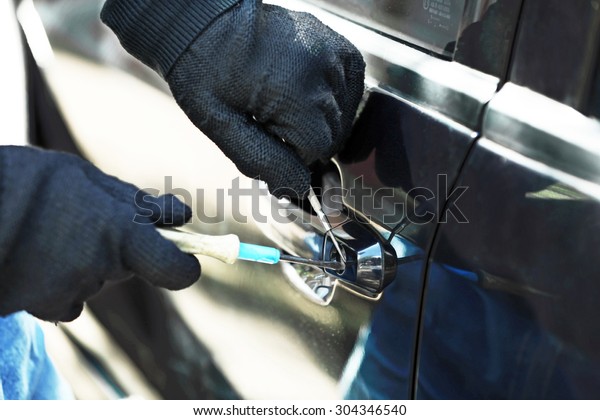 Man burglar stealing\
car
