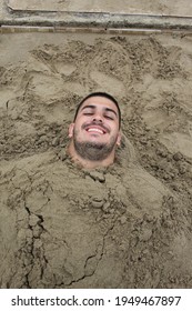 Man Buried In The Sand On A Beautiful Beach