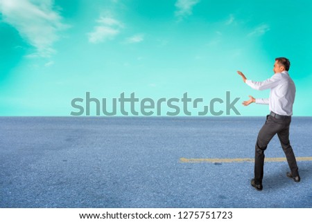 Man business asian hand gestures power wave on street and room sky 
blurred background. Metaphor success freedom imagination expression 
punching.Metaphor Business success fighting competition
