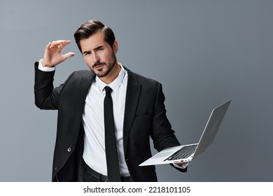 Man Business With Headache And Anger Business Negotiation Screams Online Internet By Video Call On Gray Background. Sadness And Failure To Cooperate