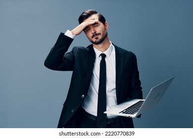 Man Business With Headache And Anger Business Negotiations Online By Video Call On Blue Background. Sadness And Failure To Cooperate, Poor Mental Well-being