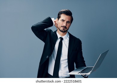 Man Business With Headache And Anger Business Negotiations Online By Video Call On Blue Background. Sadness And Failure To Cooperate, Poor Mental Well-being