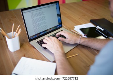 Man business planning expert working on laptop computer. Male content writer for financial  presentation using modern notebook. Hipster guy skilled e-book writer using net-book, sitting at desktop