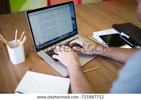 Man business planning expert working on laptop computer. Male content writer for financial  presentation using modern notebook. Hipster guy skilled e-book writer using net-book, sitting at desktop