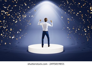 Man in a business suit celebrating on a podium under a spotlight with confetti. Dark background. Concept of success and victory