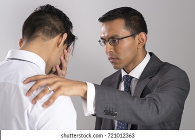 Man In Business Suit Consoles Grieving Friend