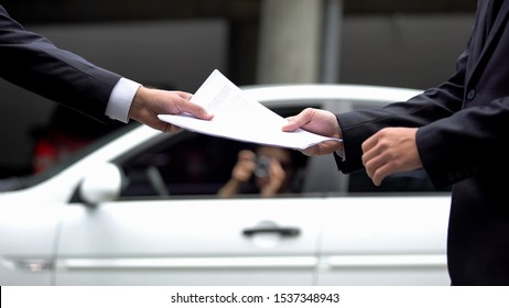 Man in business suit giving secret documents to business partner, information
