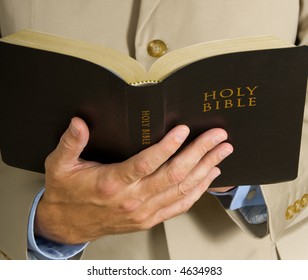 Man In Business Suit Or Preacher Holding The BIble