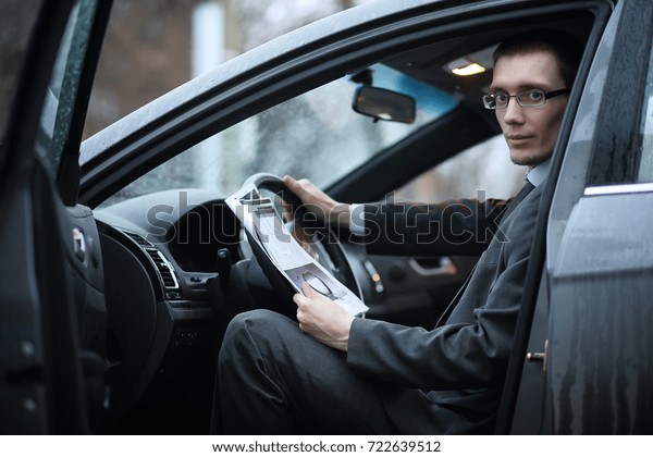 the man in\
a business suit is sitting in the\
car\
